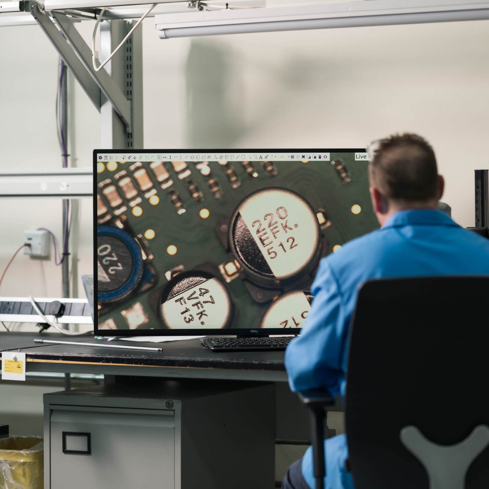 man-looking-at-circuit-board-on-screen.jpg